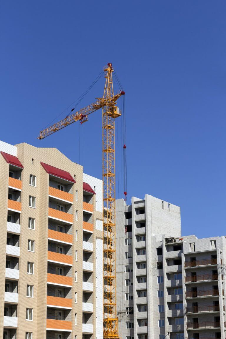 Industrial landscape, building crane against the blue sky